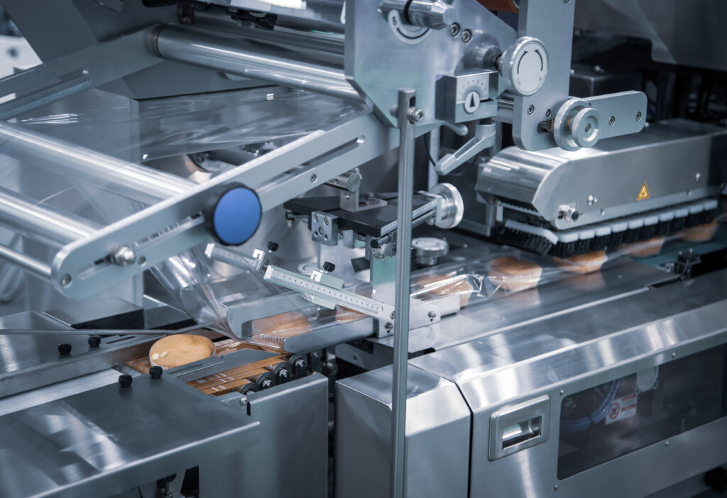 Bread, toast, bun plastic wrapping machine on bakery production line