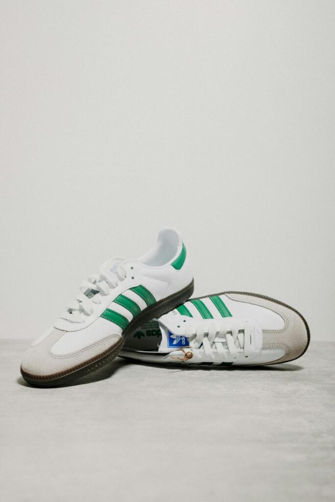 Ein Paar weiß-grüne adidas Samba Sneaker