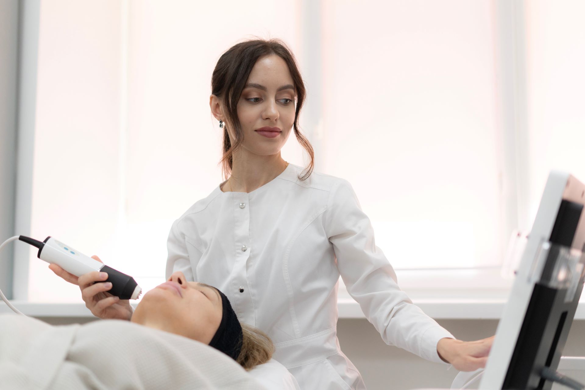 Kosmetikerin führt Behandlung mit Gerät durch – dauerhafte Haarentfernung Essen